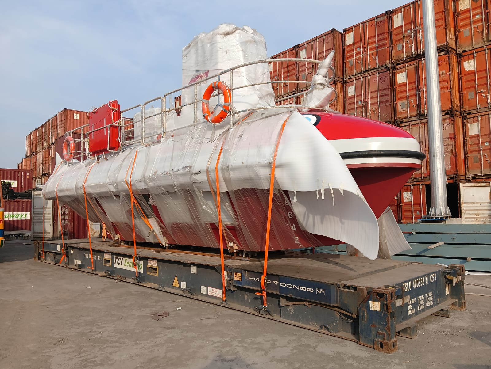 Boat loaded on a flatrack container for shipping