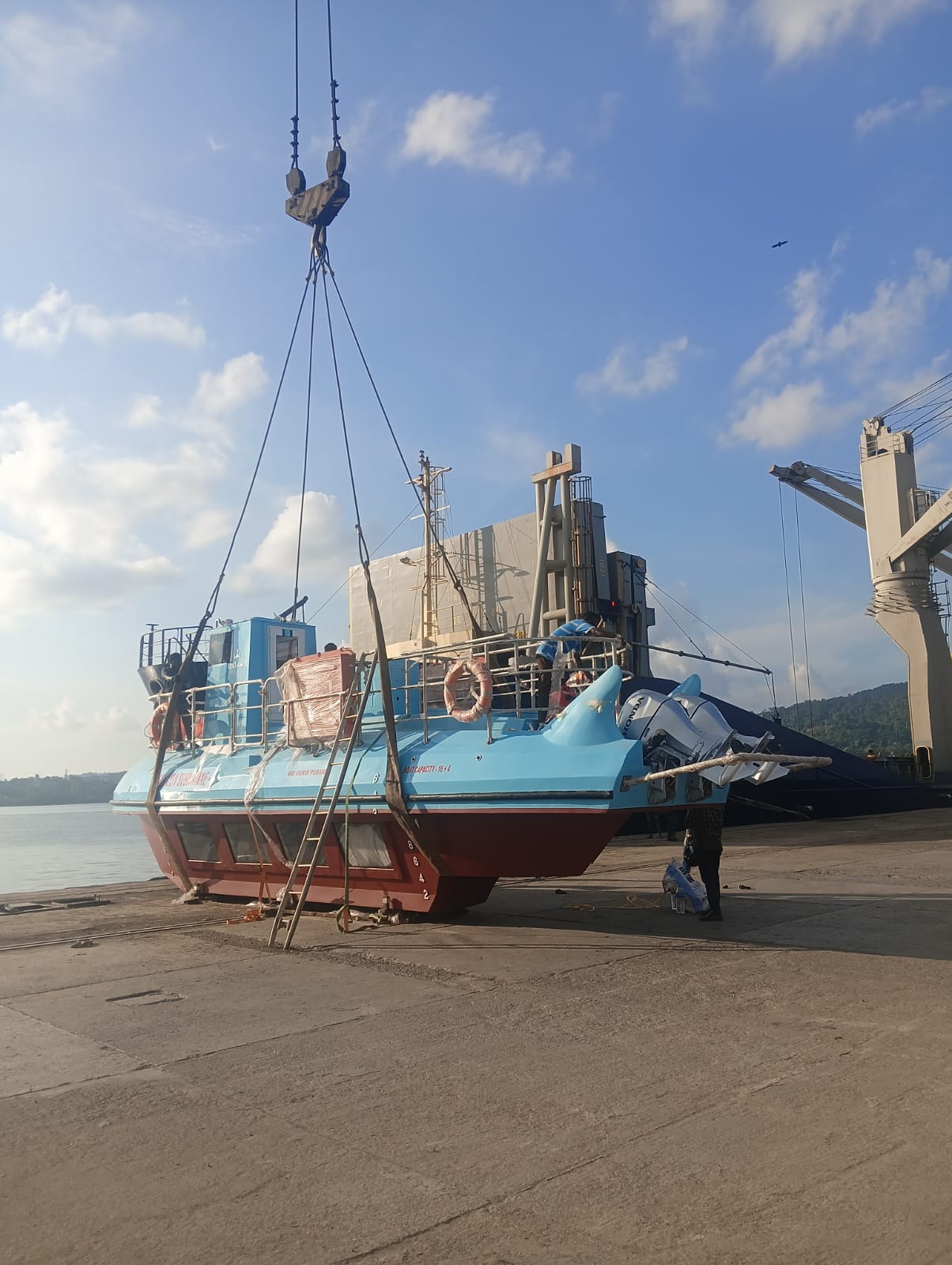 Boat being unloaded from a container